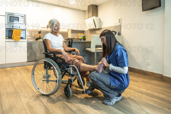 Physiotherapist in uniform giving gentle foot massage and rehabilitation treatment to a smiling
