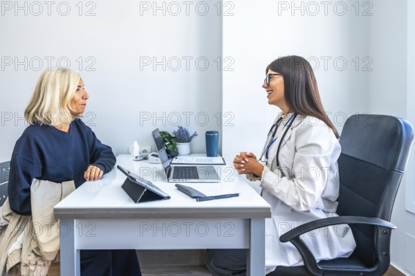 Doctor consulting with an older woman, having a medical appointment in a modern office, providing