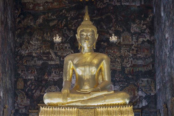 Golden Buddha statue, Phra Buddha Trilokachet surrounded by crystal chandeliers and exquisite wall
