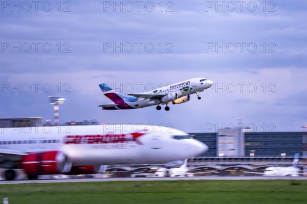 Corendon Airlines Boeing 737-800 landing at Düsseldorf airport, Eurowings Airbus taking off, North