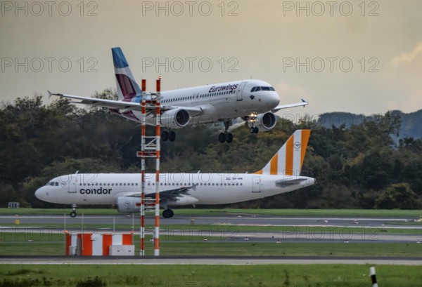 Eurowings Airbus landing at Düsseldorf airport, Condor Flieger waiting for takeoff, North