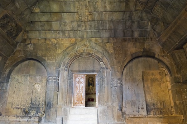Detail of an ancient stone building with wall engravings and reliefs that conveys a historically