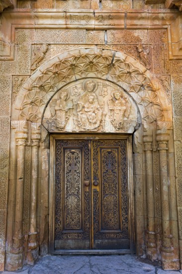 Elaborately carved wooden gate with beautiful stone decorations and architectural details, Noravank