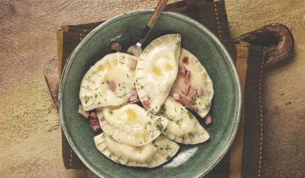 Dumplings, with fried prosciutto, a traditional dish of Polish cuisine, dumplings, top view,