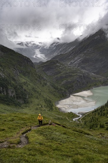 Hikers in a cloudy mountain landscape, Margaritzen Reservoir, Grossglockner High Alpine Road, Hohe
