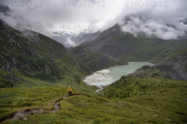 Hikers in a cloudy mountain landscape, Margaritzen Reservoir, Grossglockner High Alpine Road, Hohe