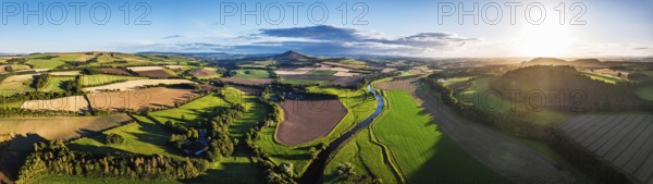 Panorama of evening Fields and Farms over River Teviot and Minto Crags from a drone, Roxburghshire,