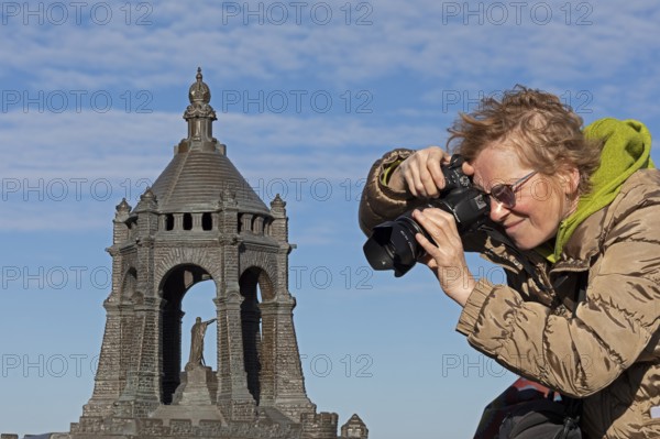 Woman photographing model, Kaiser Wilhelm Memorial, Porta Westfalica, North Rhine-Westphalia,