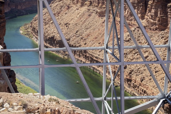 Marble Canyon, Arizona - Dories float under the Navajo Bridge which spans the Colorado River in
