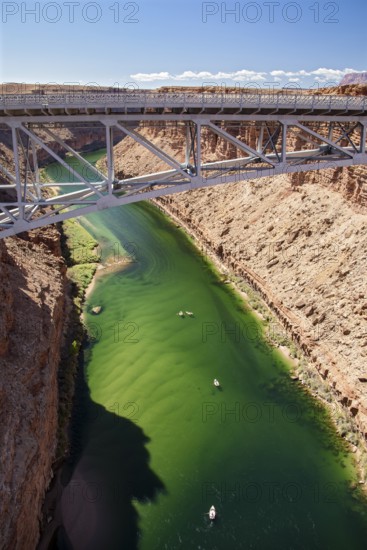 Marble Canyon, Arizona - Dories float under the Navajo Bridge which spans the Colorado River in
