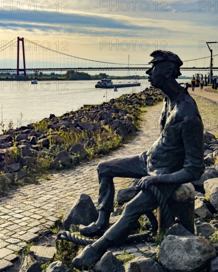 Photo with melancholy mood of bronze sculpture Poortekerl looking at Rhine waiting for ship to