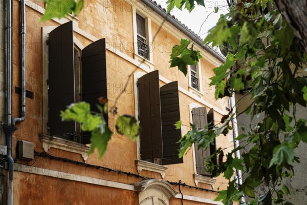 Facade, orange, shutters, Arles, France