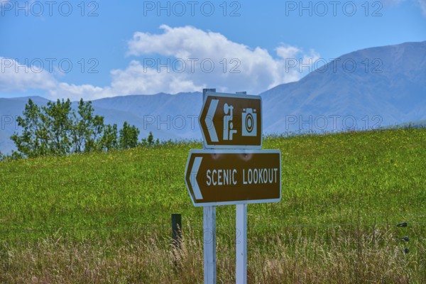 Scenic Lookout sign with photo camera icon against green mountain landscape, Geraldine Fairlie