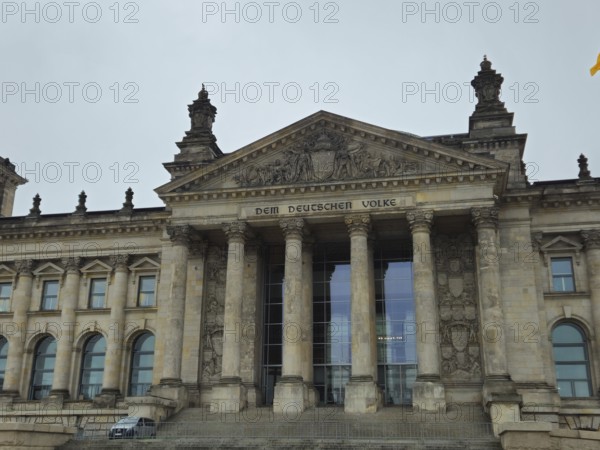The Reichstag building, magnificent parliament façade with inscription and tall pillars, frontal in