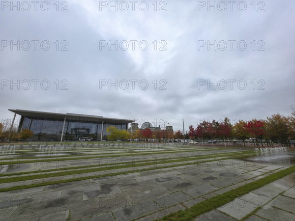 Extensive square with water fountains in the government district under heavy cloud cover in the