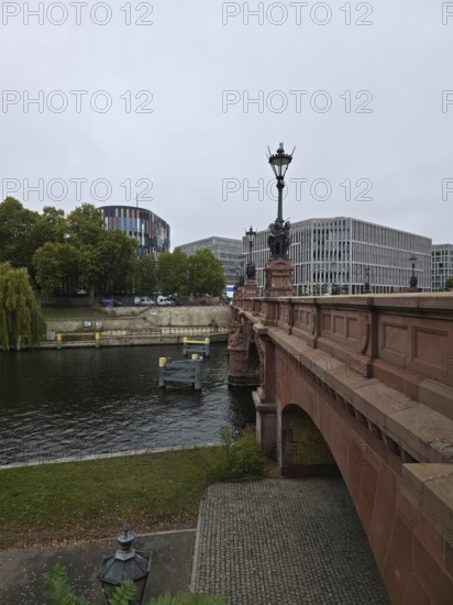 The Moltke Bridge, historic bridge across the Spree with wrought-iron chandelier, flanked by modern