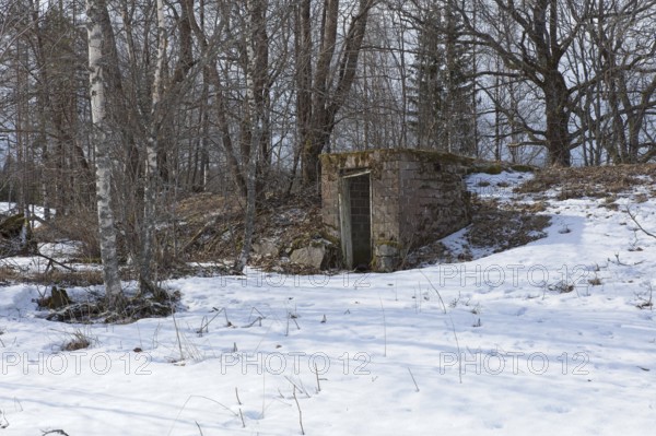 Old abandoned brick cellar under the ground in winter, Junkarsborg, Finland