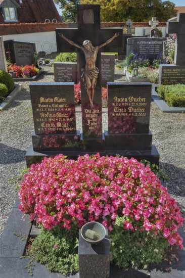 Graves with crucifix and floral decoration in Maria-Thann, Allgäu, Swabia, Bavaria, Germany
