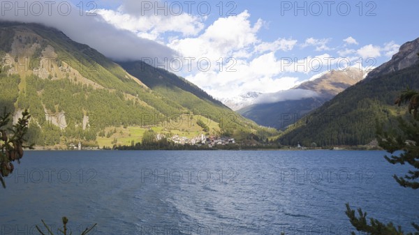 View over Lake Reschen to the village of Graun in Vinschgau, which is beautifully situated in the