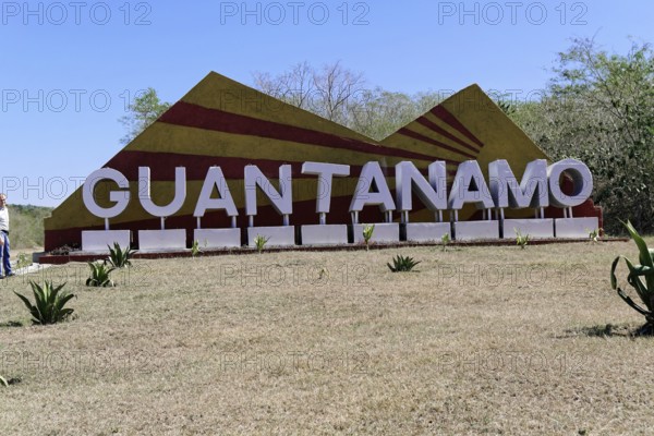Large sign with 'Guantánamo' in a meadow surrounded by nature, Cuba, Greater Antilles, Caribbean,