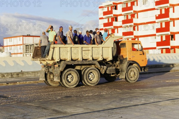 Baracoa, Cuba, Central America, Open truck loaded with workers on a wide, empty road, Greater