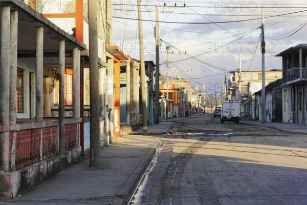 Baracoa, Cuba, Central America, Deserted street with empty sidewalks and visible old buildings,