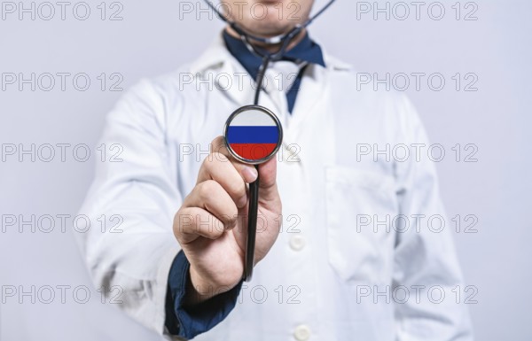 Doctor hands holding stethoscope with Russia flag. Russia health and care concept