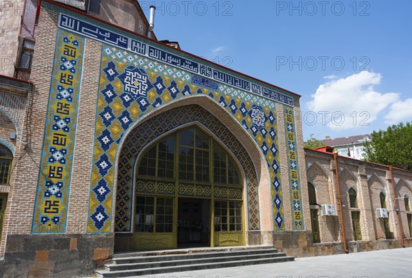 Building with intricate tile patterns and lettering on an archway, Blue Mosque, Shiite Mosque,