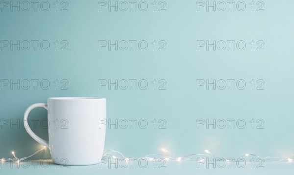 A white coffee cup sits on a blue background. The cup is the main focus of the image, and the blue