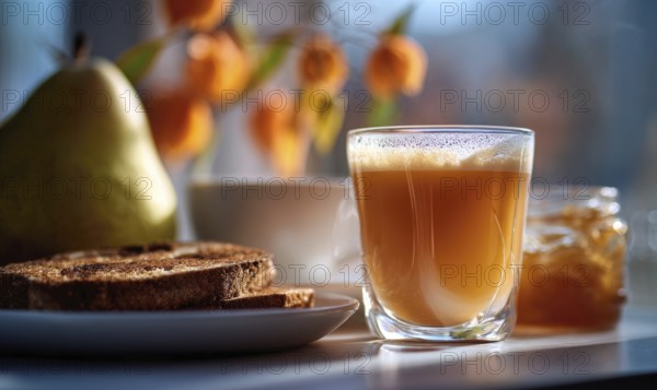 A glass of tea sits on a table next to a plate of toast and a jar of jam. Concept of comfort and