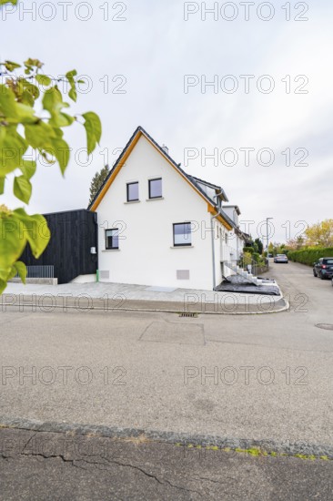 Gable view of a semi-detached house on a quiet residential street with minimalistic design, house