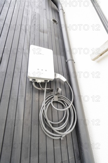 White wallbox on black wooden façade, house renovation, climate renovation, Metzingen, Germany