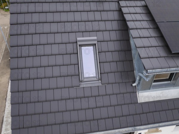 Detailed view of a roof with skylight near the gutter, house renovation, climate renovation,
