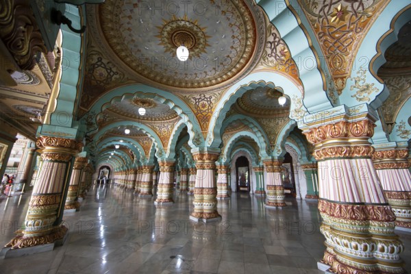 Granite columns with ornate arches and stucco ceilings, Durbar Hall in Mysuru Palace or Amba Vilas