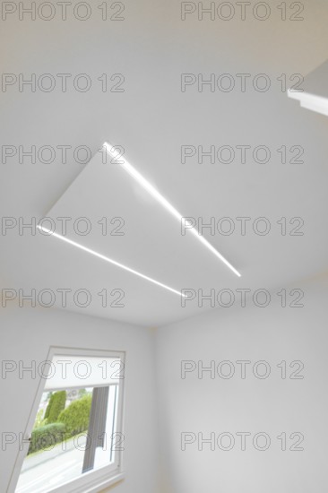 Modern white ceiling with two slim LED lines, geometric light detail near window, house renovation,