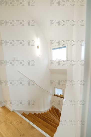 Light wooden staircase in white, minimalistic staircase with window, house renovation, climate