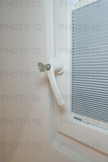 Detail of a white window handle with integrated blind, clean and modern, house renovation, climate
