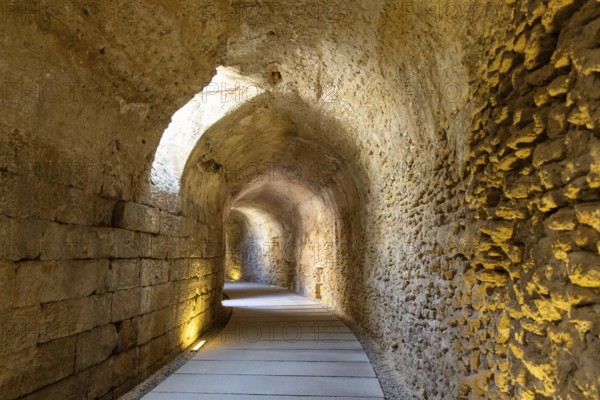 An old historic theatre in the middle of a city. Access tunnel to seats. The ruin was uncovered,