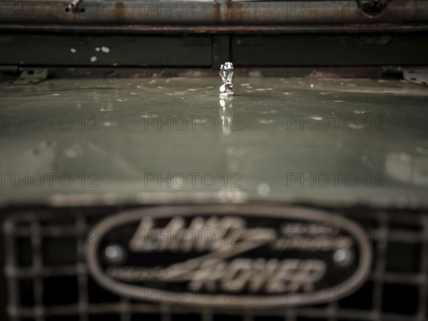 The front end of a 1950's Series One Land Rover, with a small hood ornament, parked at the Toronto