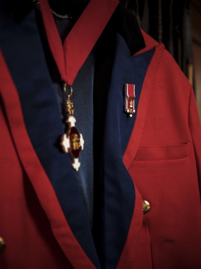 A riding jacked adorned with commemorative medals hang in the tack room at the Toronto North York