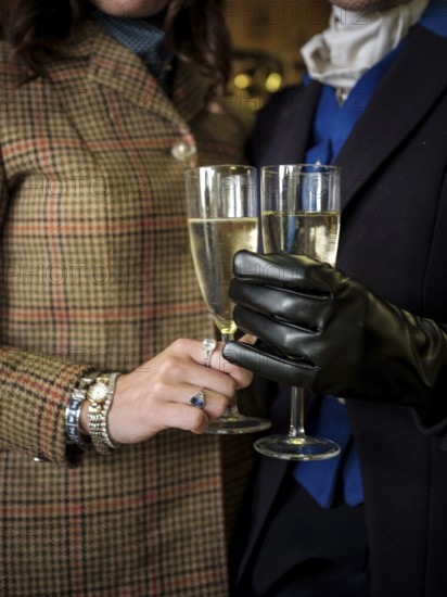Members of the Toronto North York Hunt Club, dressed in traditional hunting clothes, enjoy a glass