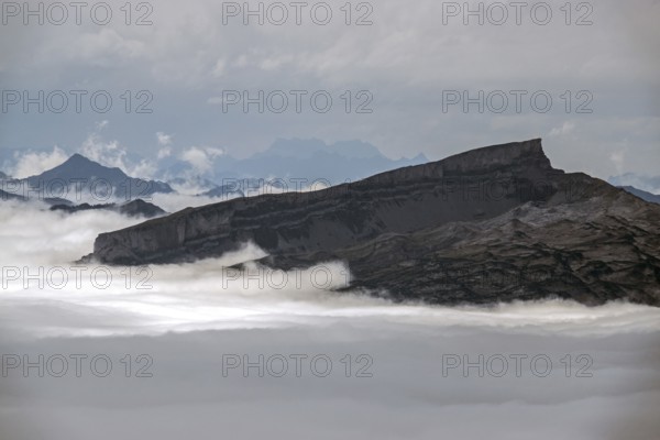 View from Nebelhorn summit on Hoher Ifen, mountains rising from fog in the valley, Oberstdorf,