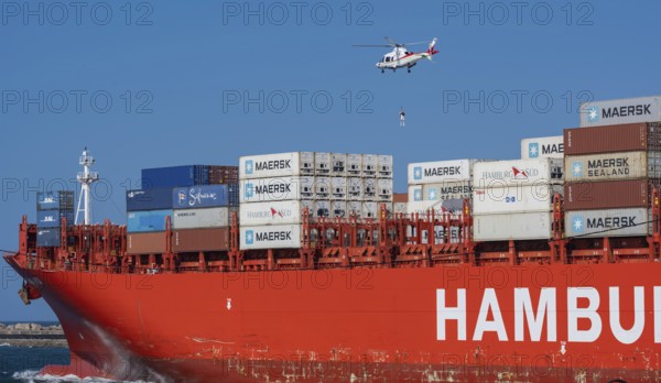 Container ship from the shipping company Hamburg Süd Santa Rita with container and helicopter to