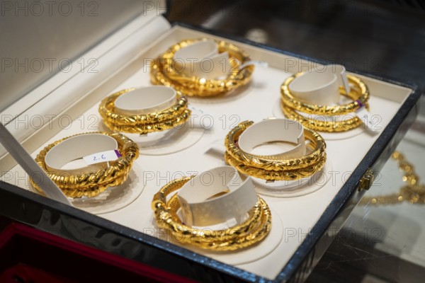 Customers purchase Gold jewelry at a store on the occasion of the festival of Dhanteras, in
