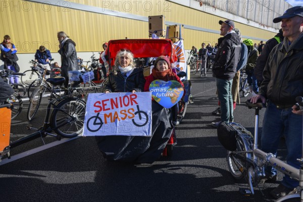 Senior women from Senior Mass and Grandmas for Future in bicycle rickshaw on A100 at a demo on the