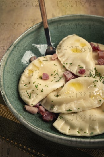 Dumplings, with fried prosciutto, a traditional dish of Polish cuisine, dumplings, top view,