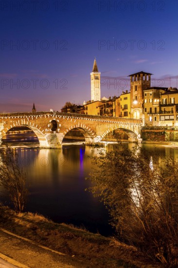 Ponte Pietra (Stone Bridge) over Adige River at evening, built by the Romans in 100 BC. Verona,