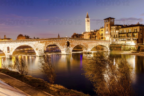 Ponte Pietra (Stone Bridge) over Adige River at evening, built by the Romans in 100 BC. Verona,