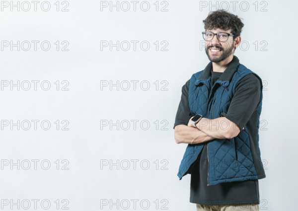 Smiling and handsome guy with glasses holding arms crossed isolated. Portrait of cool and handsome
