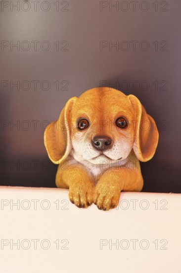 Ceramic dog looking intently in a garden, Wilnsdorf, North Rhine-Westphalia, Germany